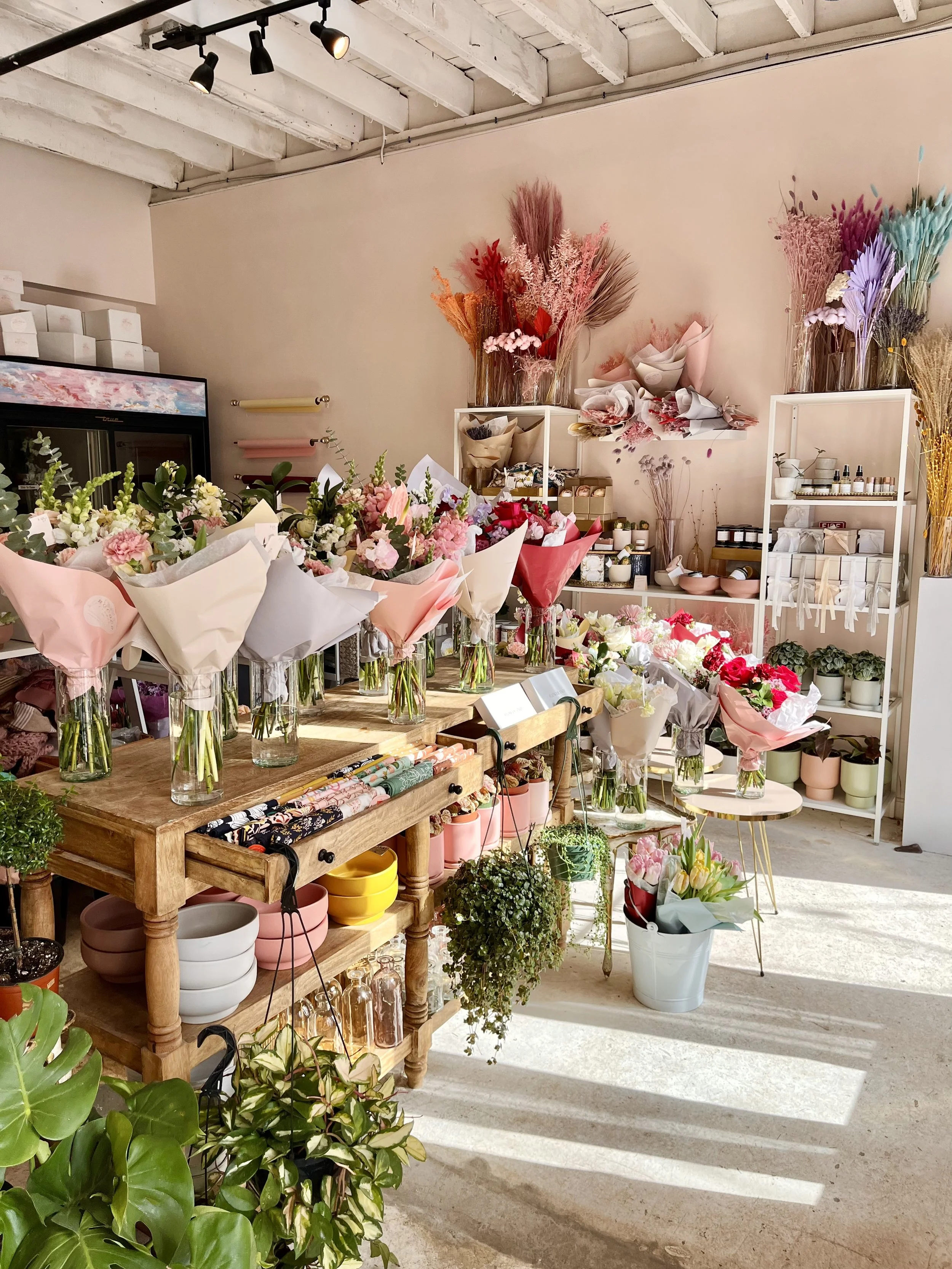 Florist designer creating custom flower arrangements in Garland Texas